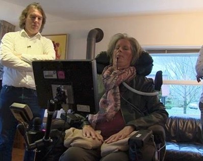 Woman in wheelchair uses communication interface.