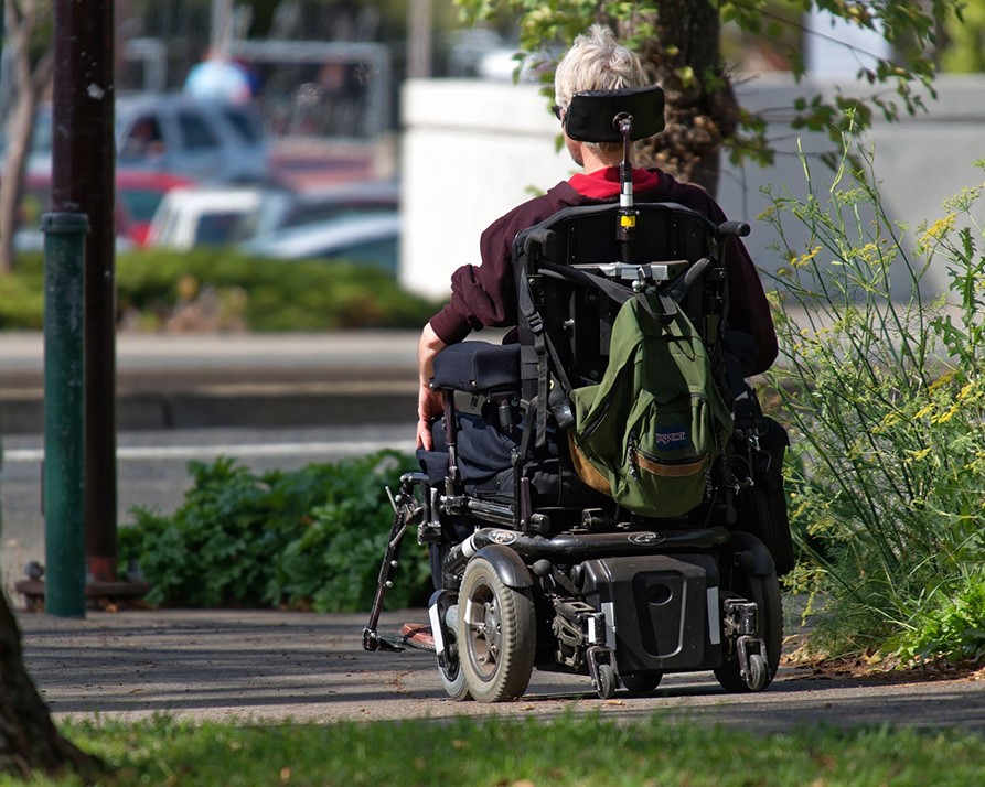 Man using motorized wheelchair.